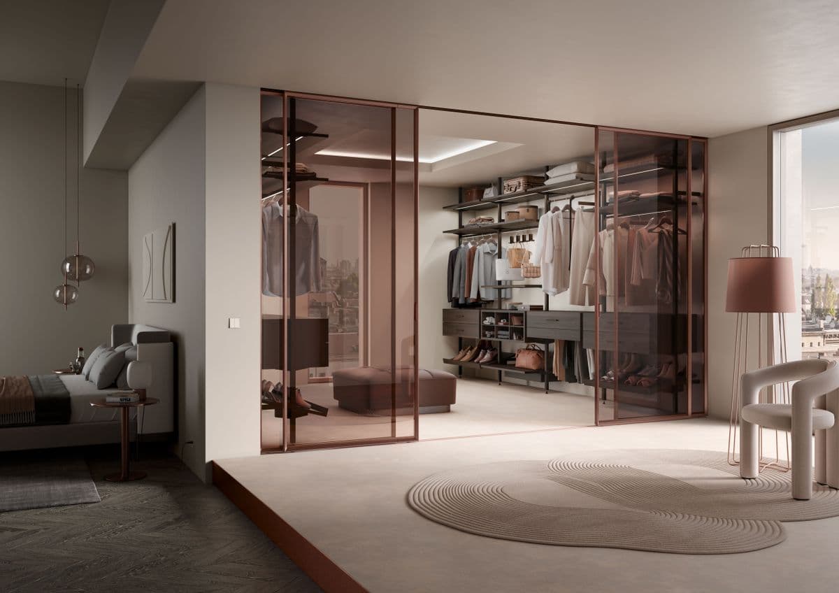 Elegant modern walk-in wardrobe with glass doors in a spacious bedroom