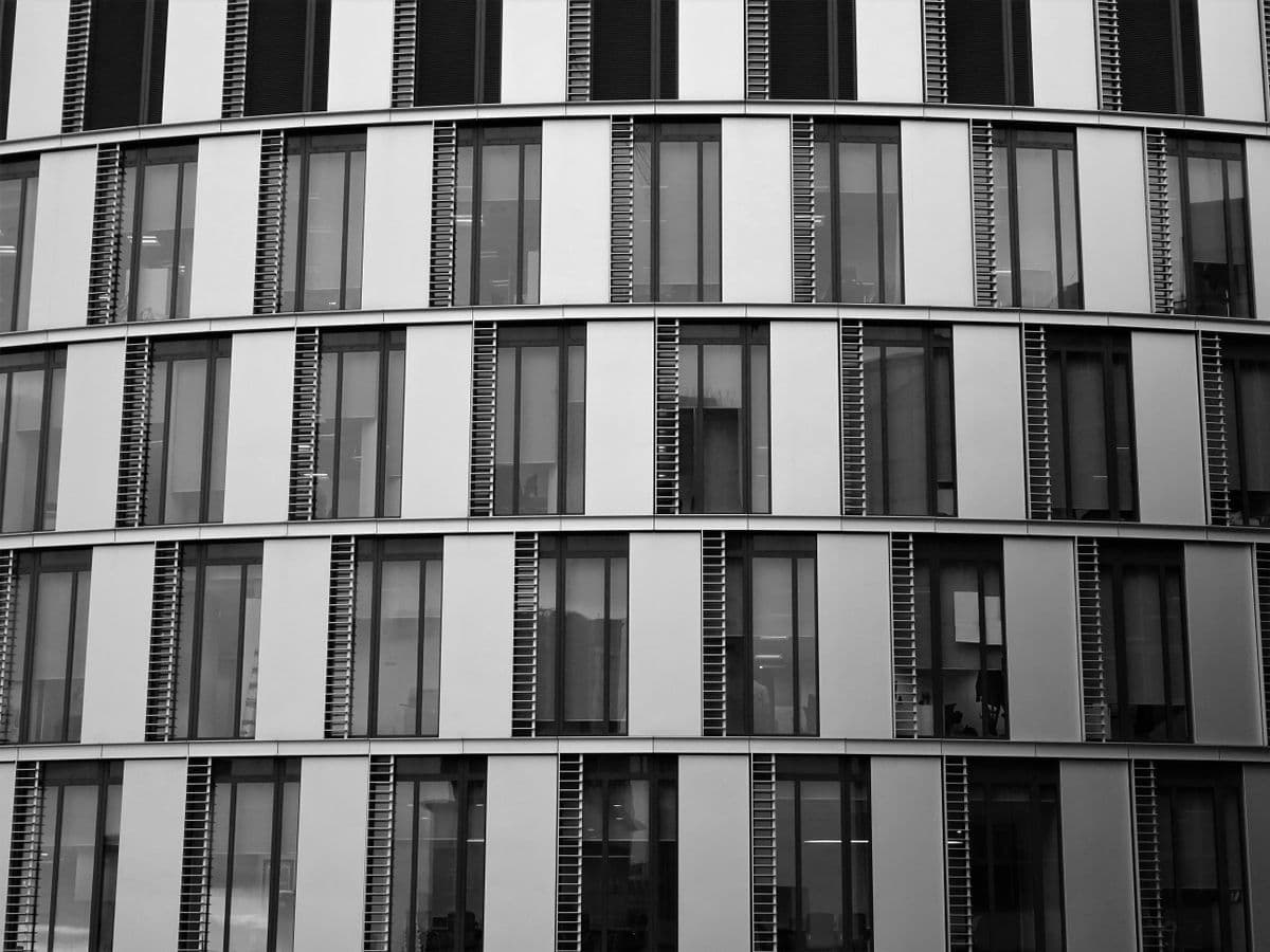 Close-up view of a contemporary office building exterior with glass and steel elements