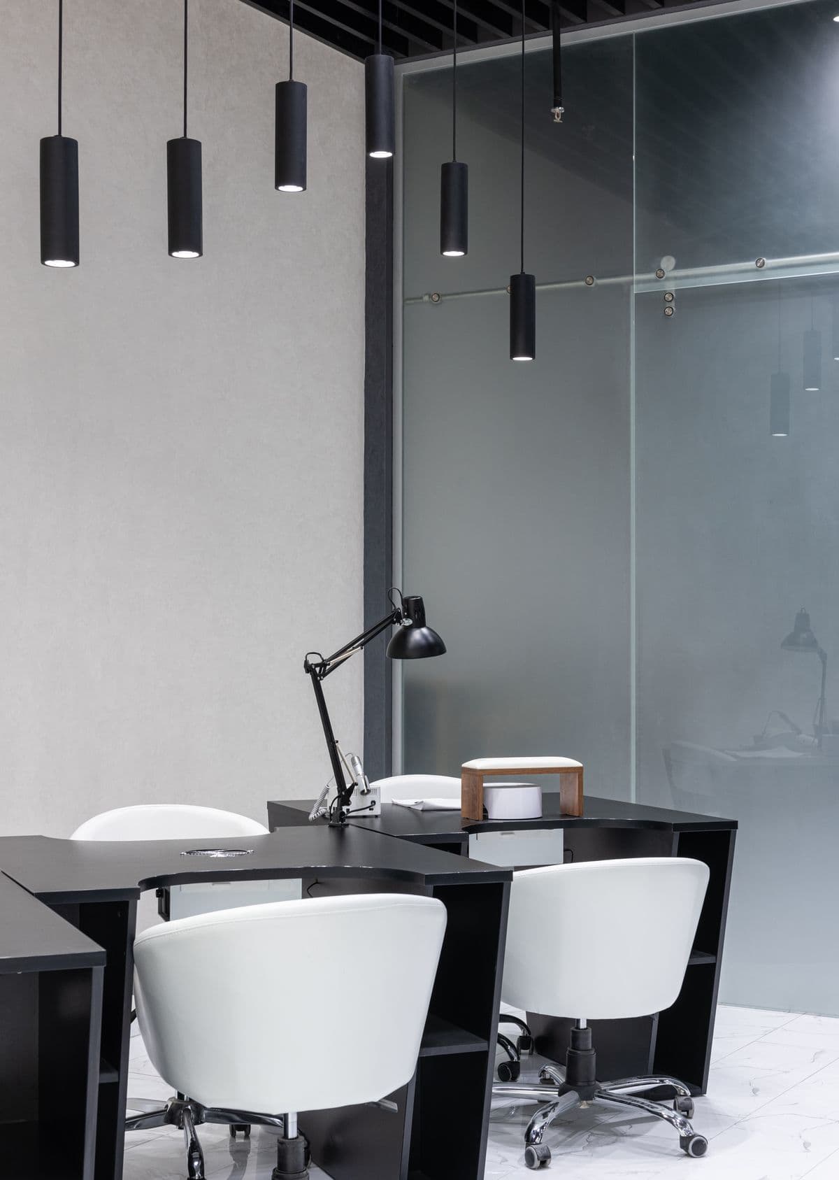 Sleek modern office interior featuring elegant black furniture and pendant lights