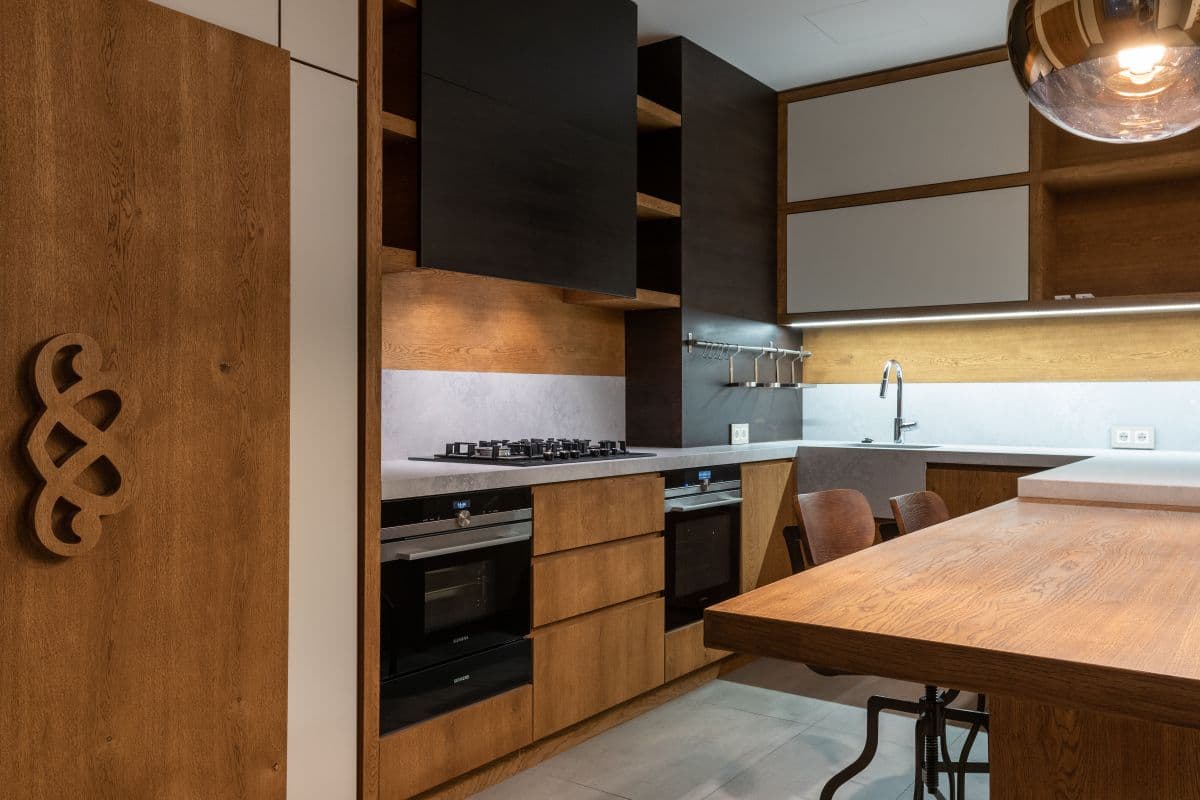 Contemporary fitted kitchen with wooden cabinetry and modern appliances